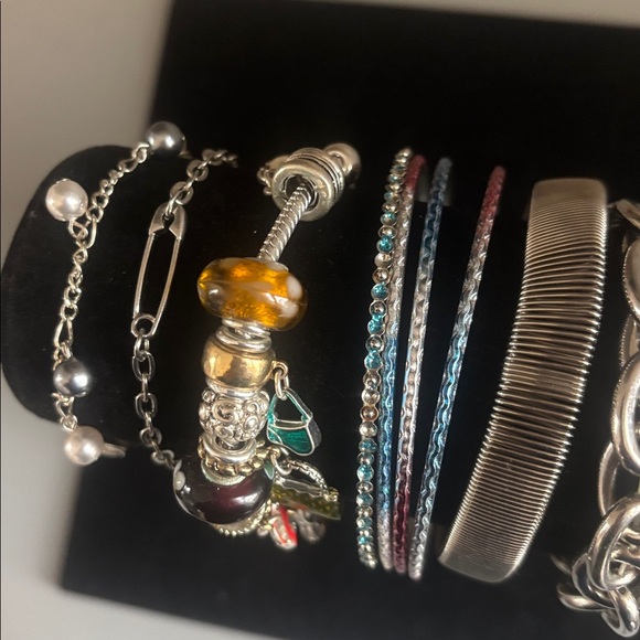 Lot of silvertone bracelets.2 are stretchy and some have adjustable chains. - Picture 2 of 5